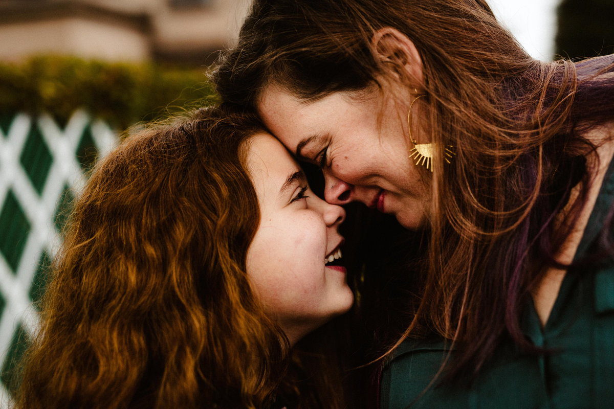 mom and daughter nuzzle noses