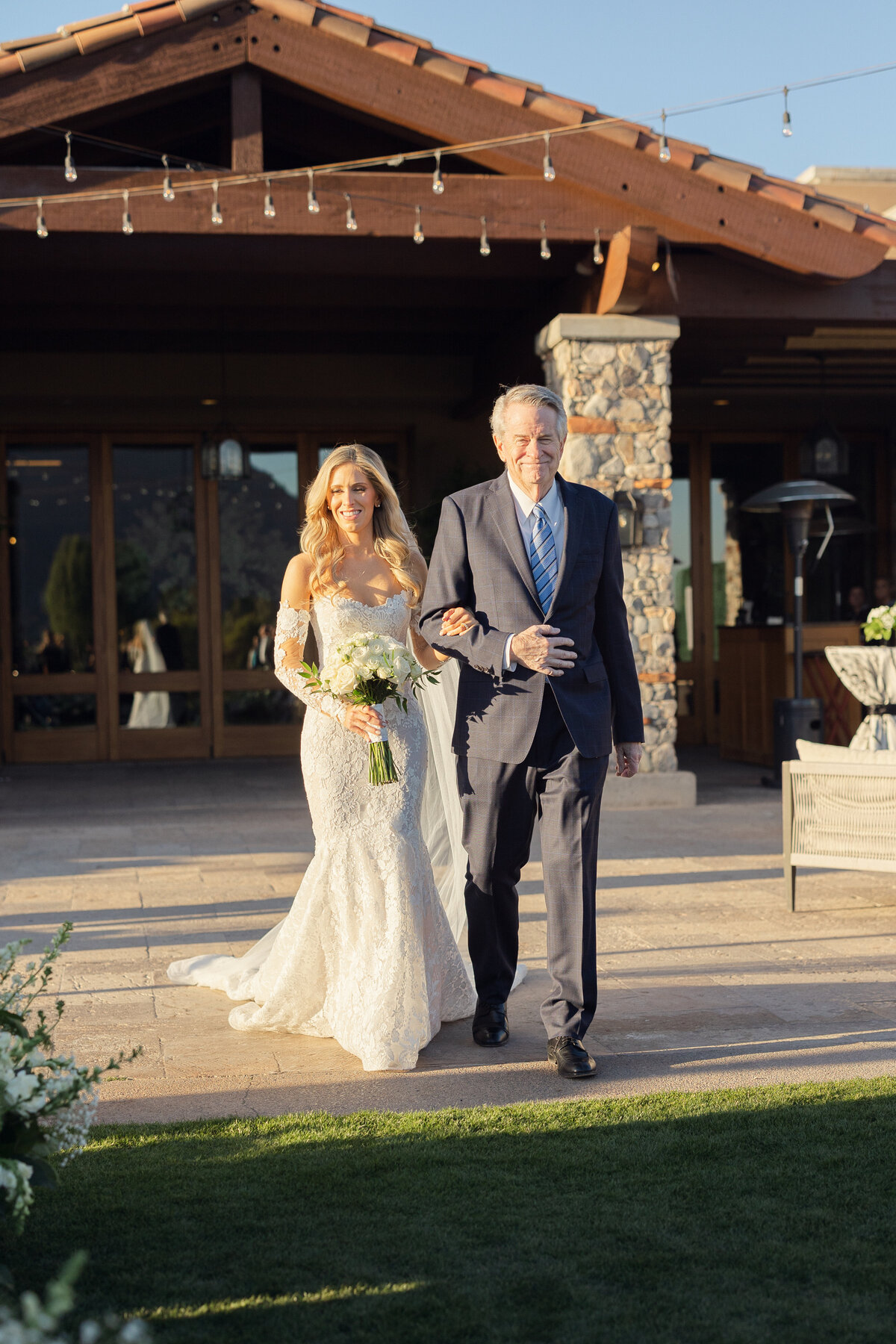Bride walking down aisle with dad at wedding ceremony in Paradise Valley, Arizona
