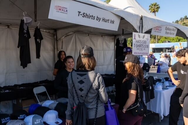 Brandy selling custom epilepsy merch at the Walk to End Epilepsy event.