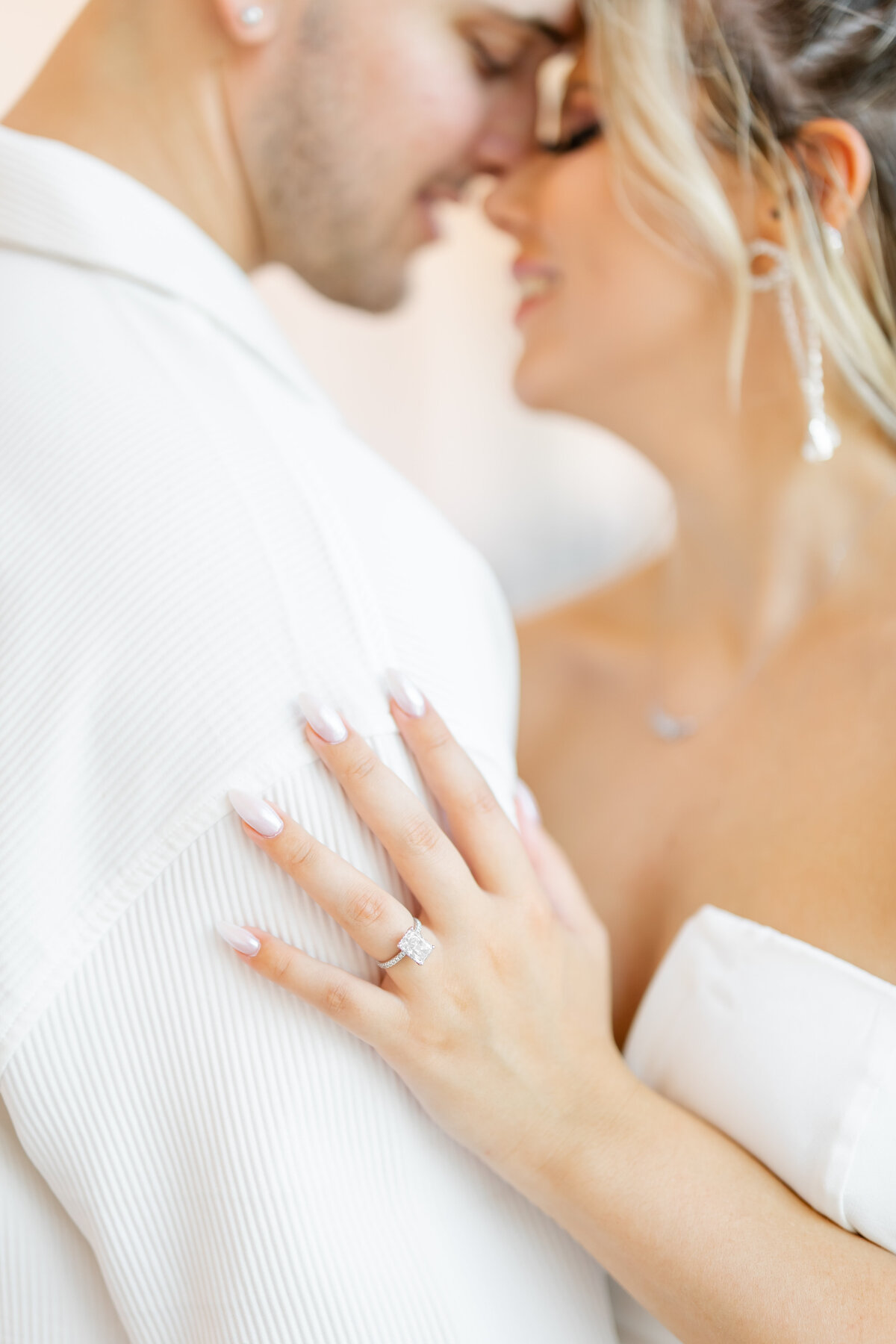 couple almost kissing and photo of engagement ring by wedding photographers fort myers