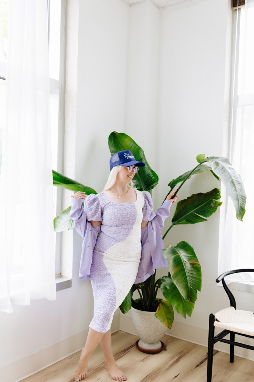 podcast host beside plant in studio