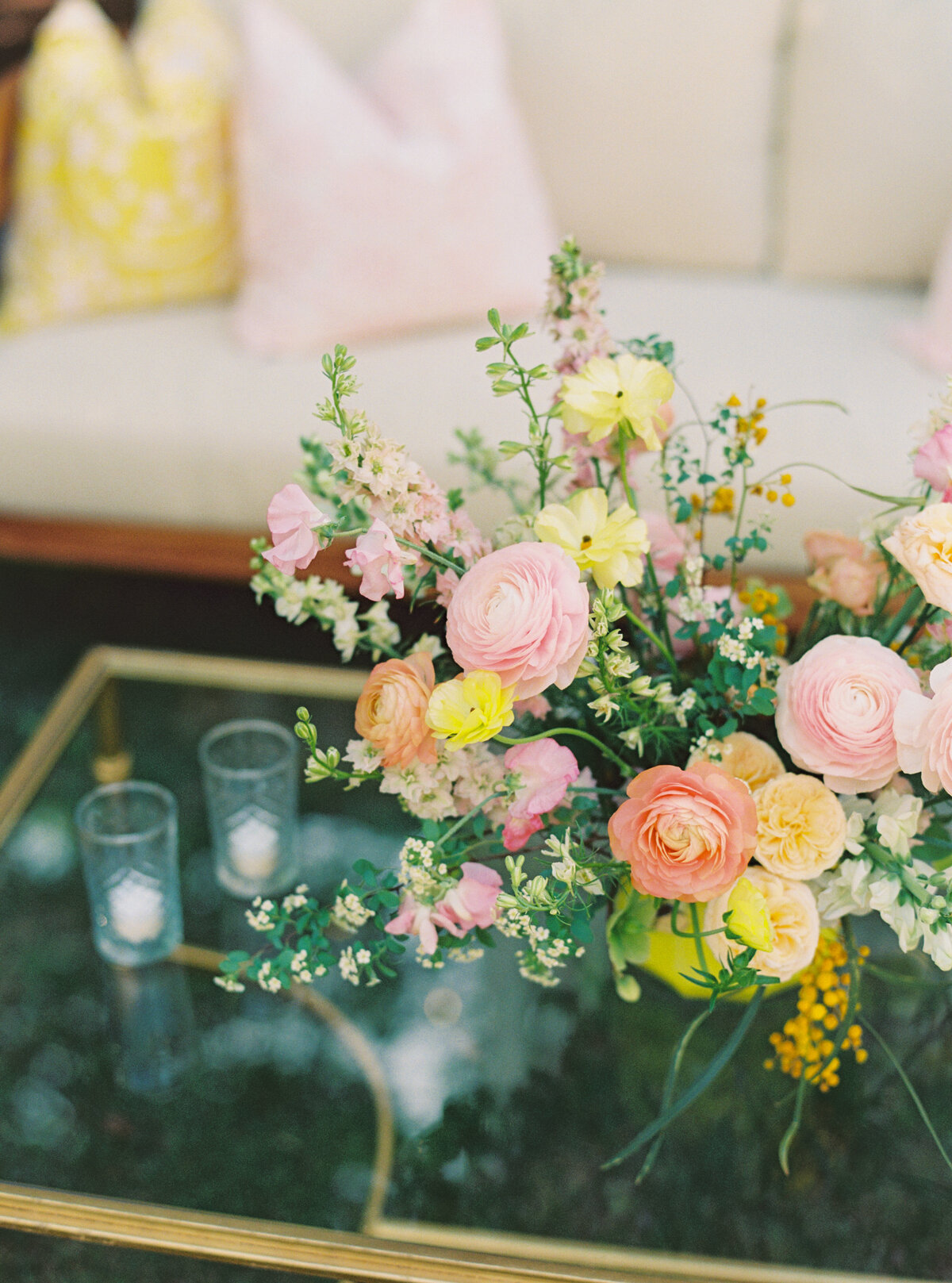 White and yellow spring wedding reception with pop of color flowers.