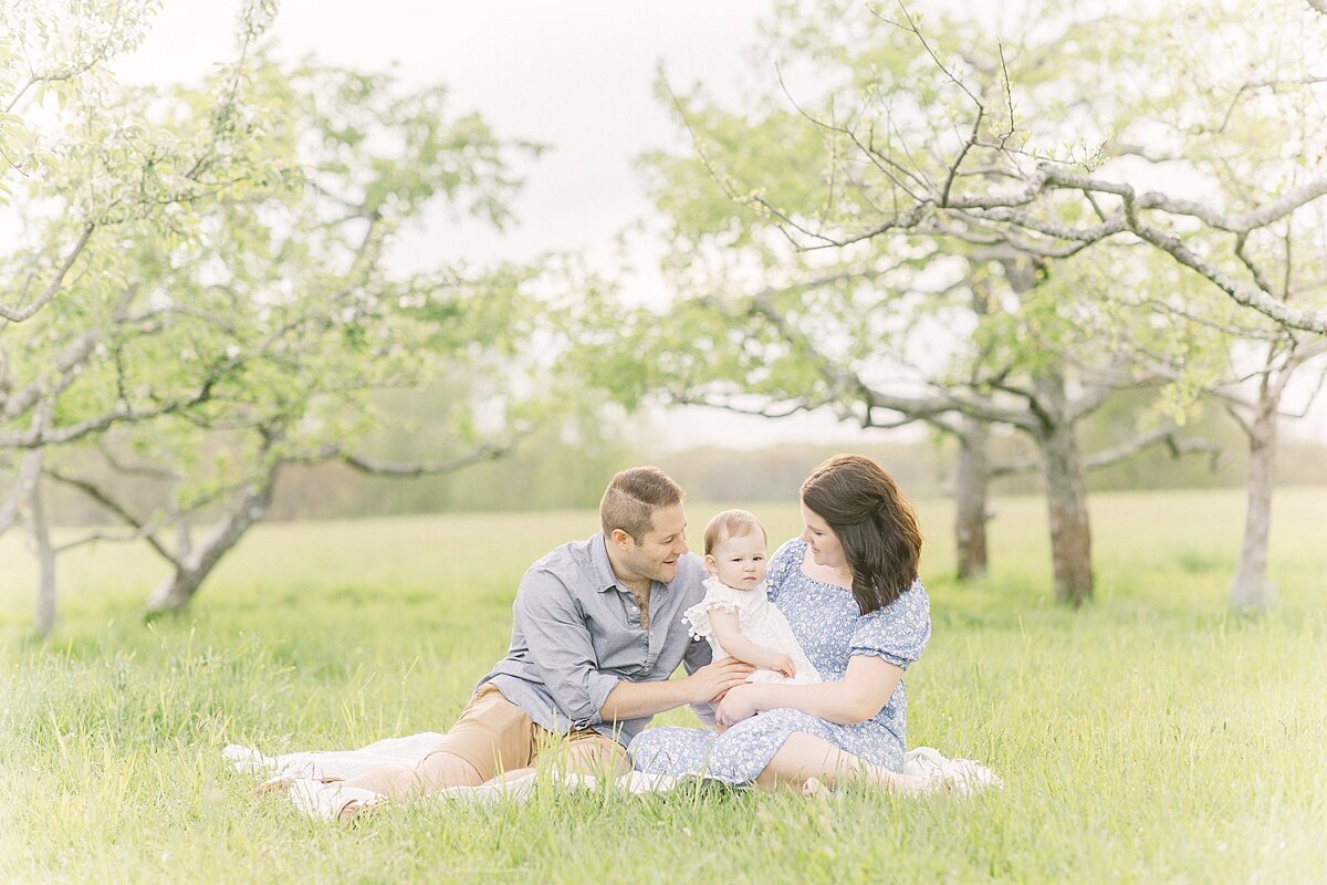 family sits osn blanket duirng spring family photo session with Sara Sniderman Photography in Natick Massachusetts