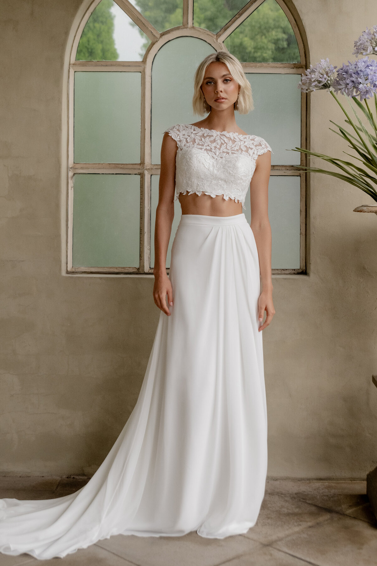 Model posing in beach wedding dress