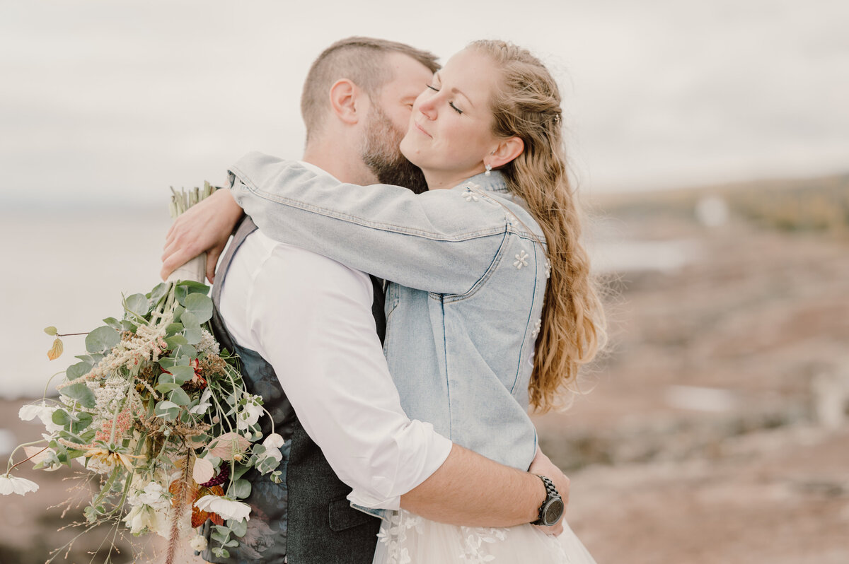 man kissing woman's neck