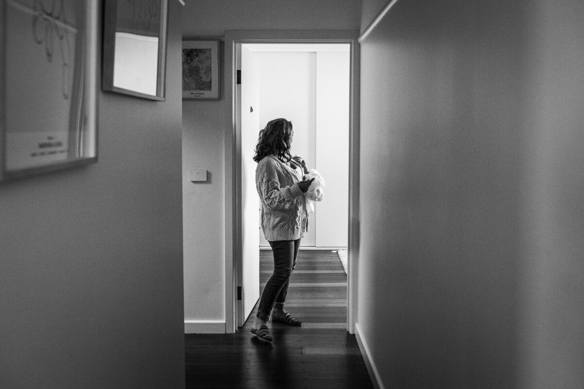 mum-standing-in-hallway-with-baby-In-Home-Newborn-Photography-Megan Browne-Melbourne-Newborn-Photographer (116)