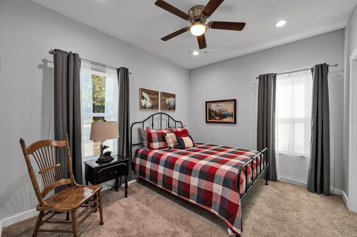 Country bedroom in this 7-bedroom, 5-bathroom farmhouse that sleeps 21 on a secluded acreage just 15 minutes from downtown Waco, TX