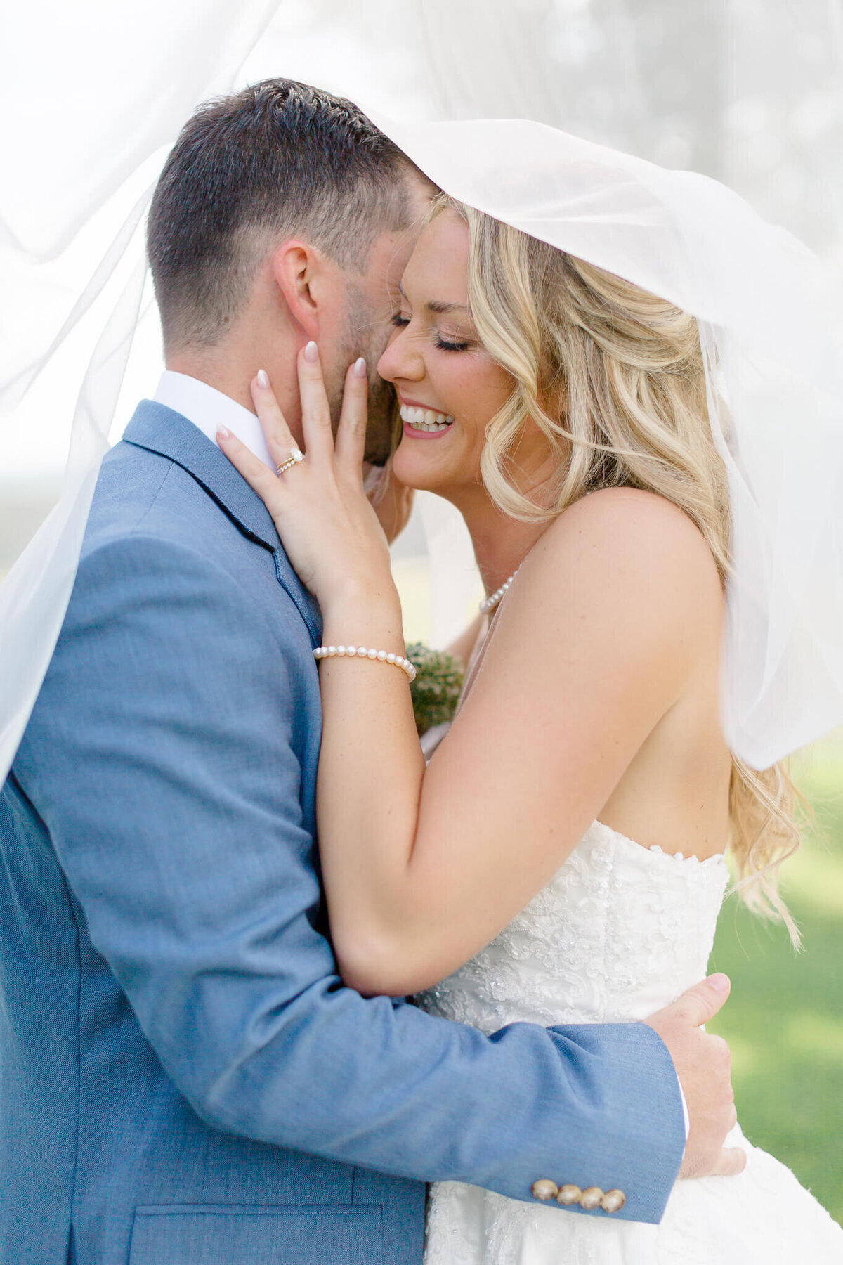 Groom making bride laugh under her veil. Taken by Washington DC Wedding Photographer Bethany Aubre Photography.