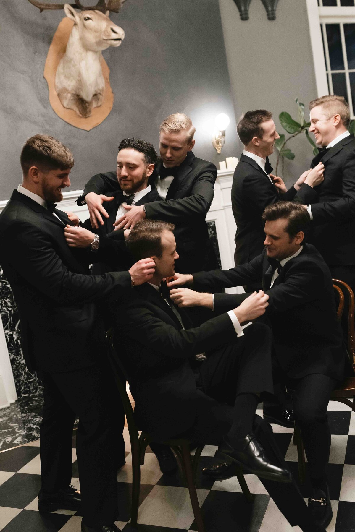 Candid wedding photo of groomsmen celebrating