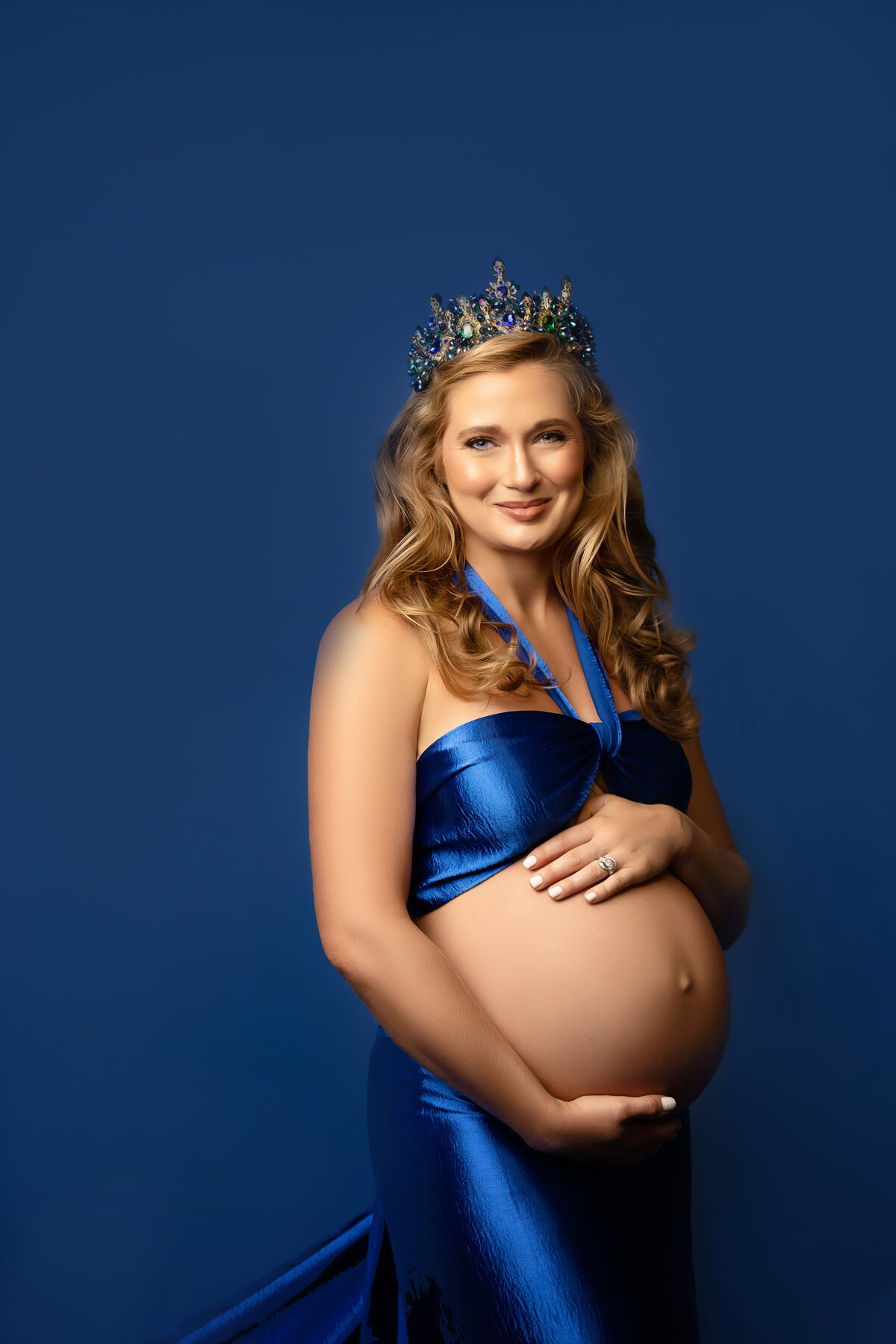 woman exposed belly royal crown blue studio