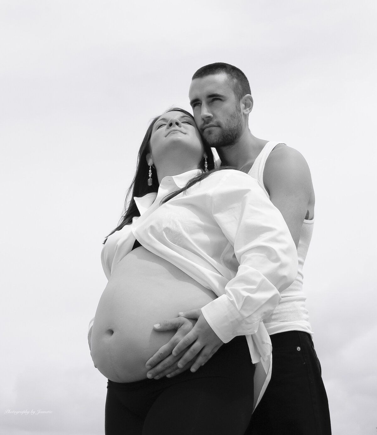 B&W photo of Pregnant woman and husband touching  her stomach