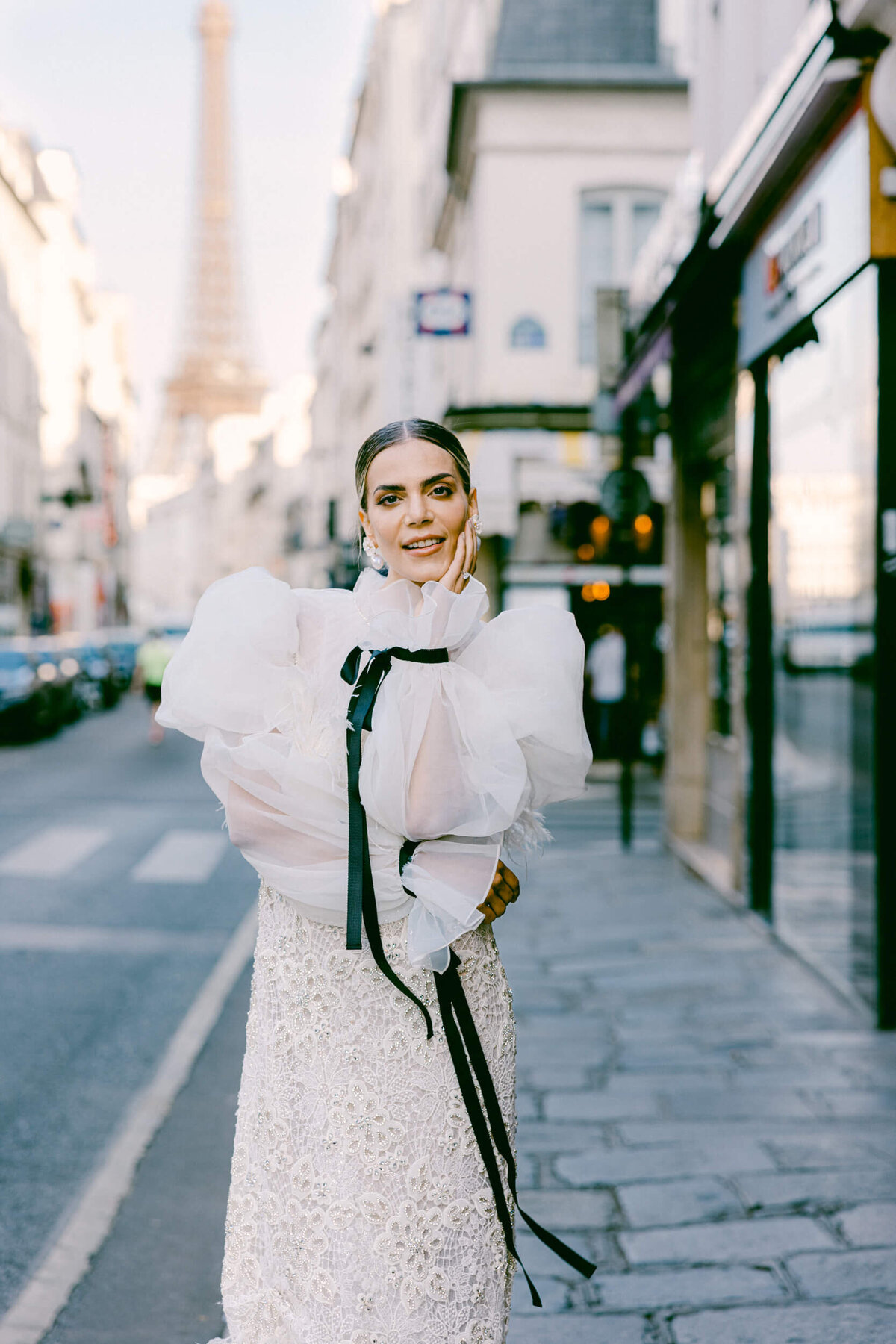A wedding photo of a bride in her white dress in the streets of Paris in France.