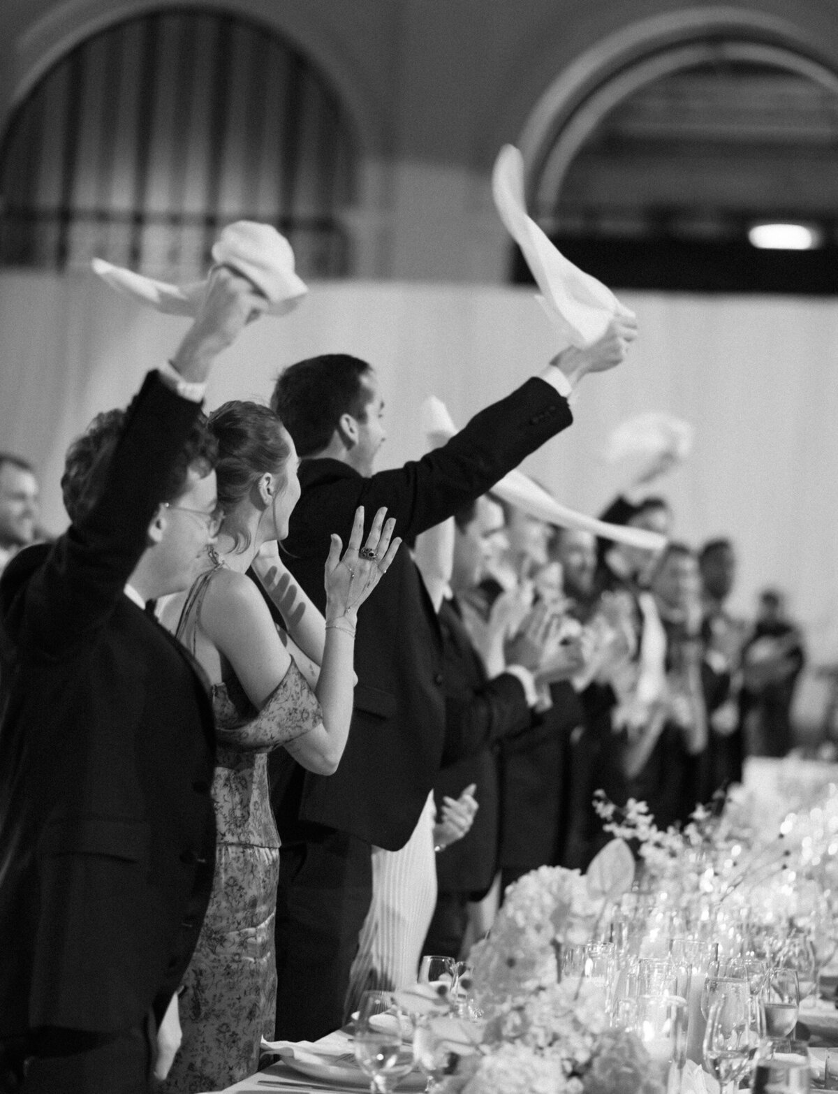 guests cheer, napkins in the air as a couple enters their State Savings Bank wedding reception in Detroit