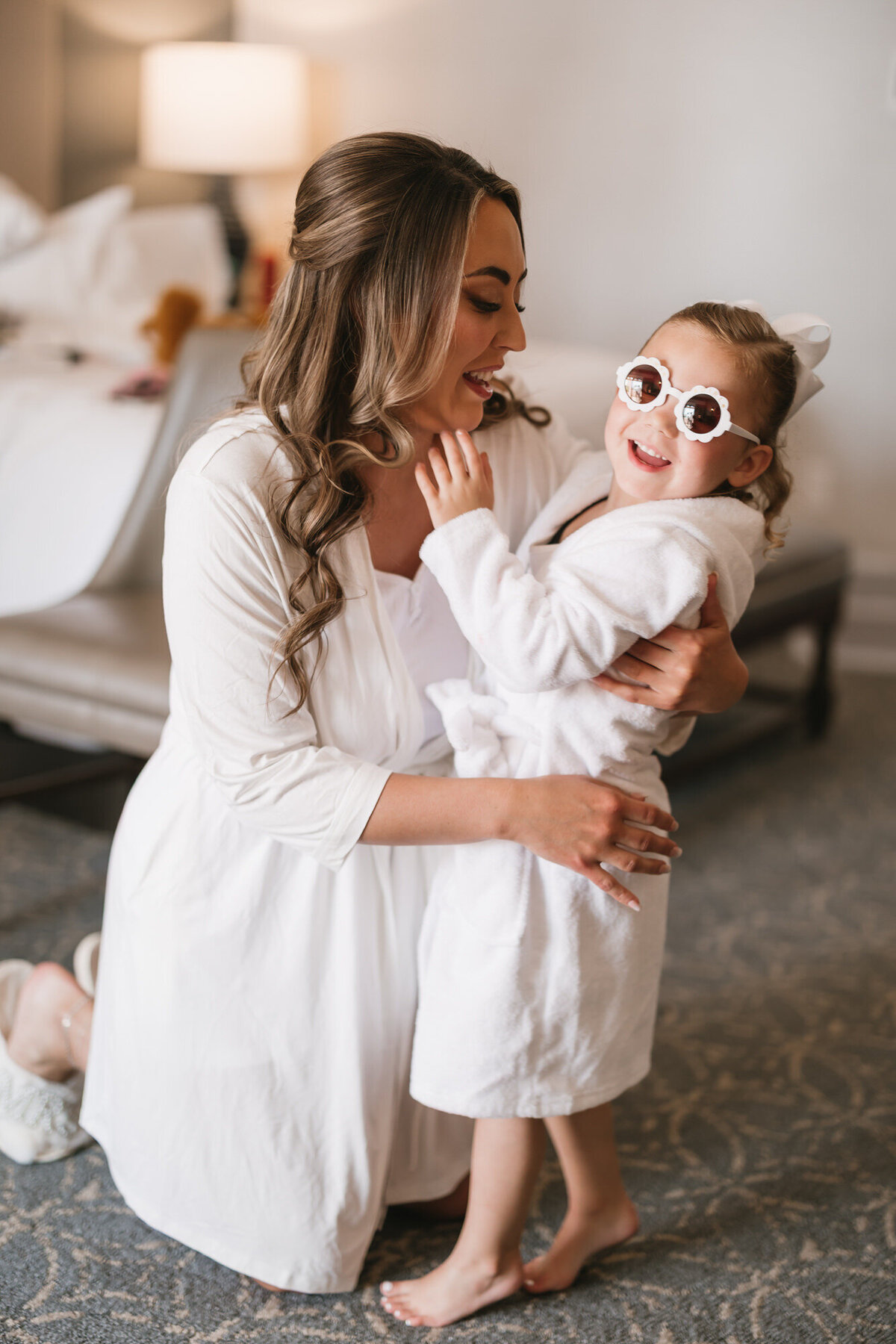 Bride and daughter sharing a moment while getting ready for wedding day at Hilton Beachfront Resort Santa Barbara