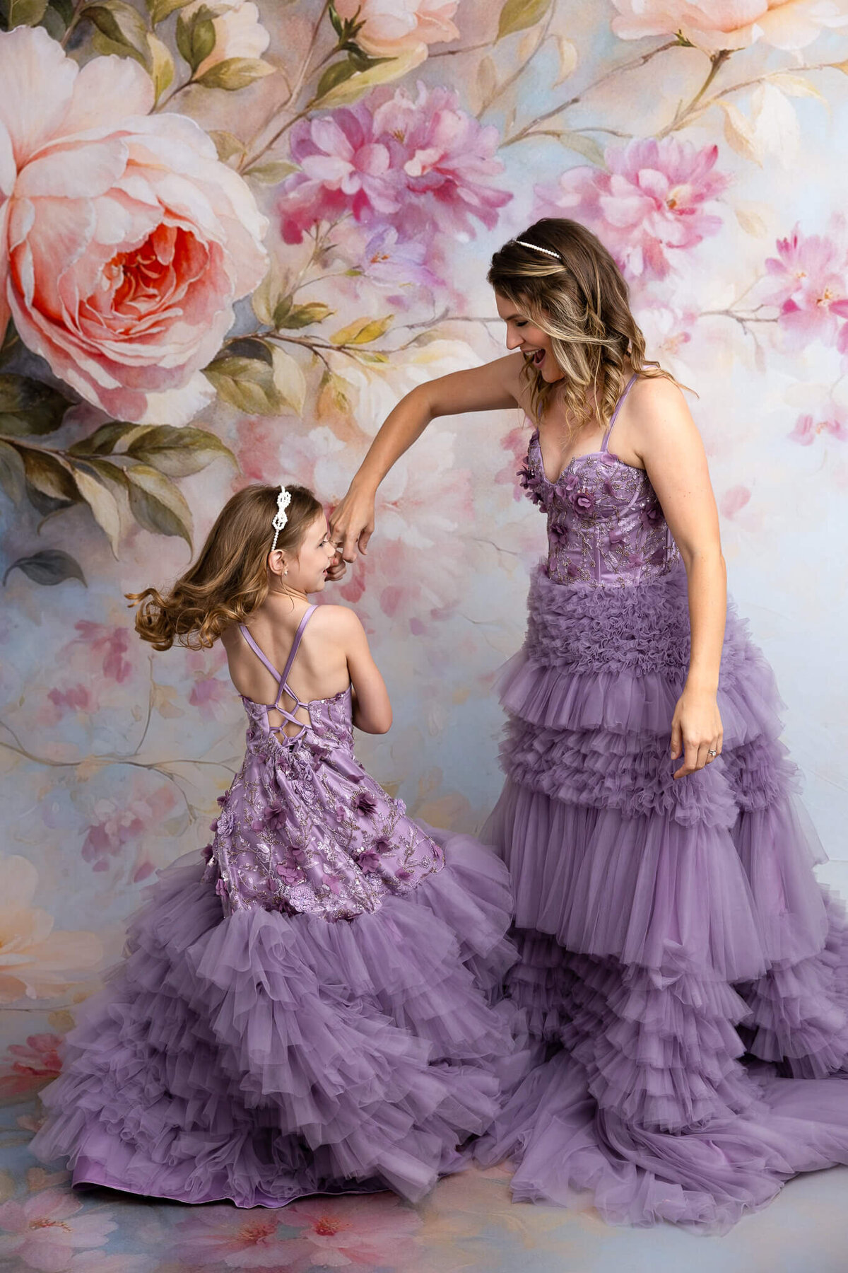Mother and daughter twirling together in dream dresses near San Antonio