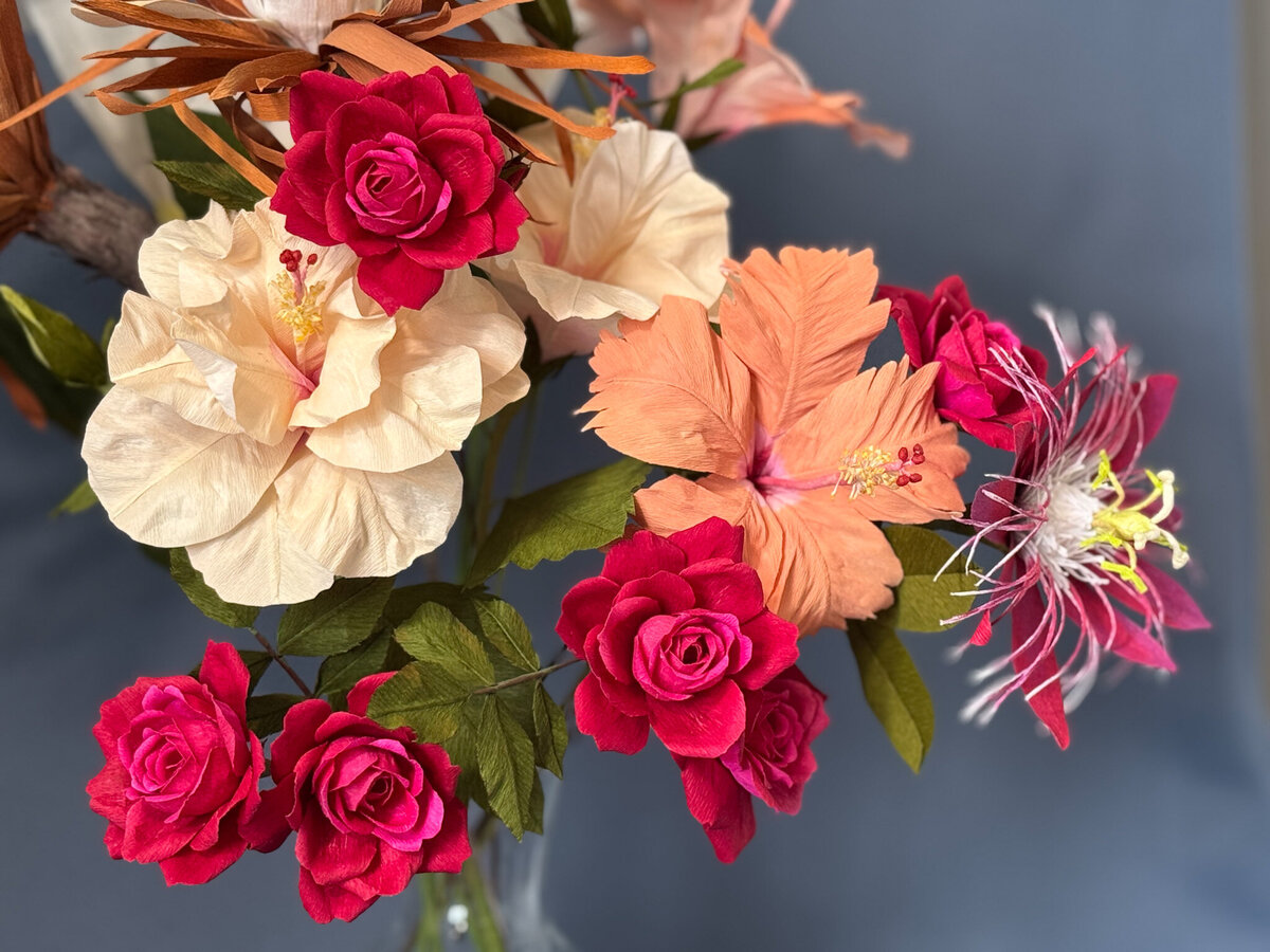 Hibiscus, passionflower and roses in deep pink and apricot