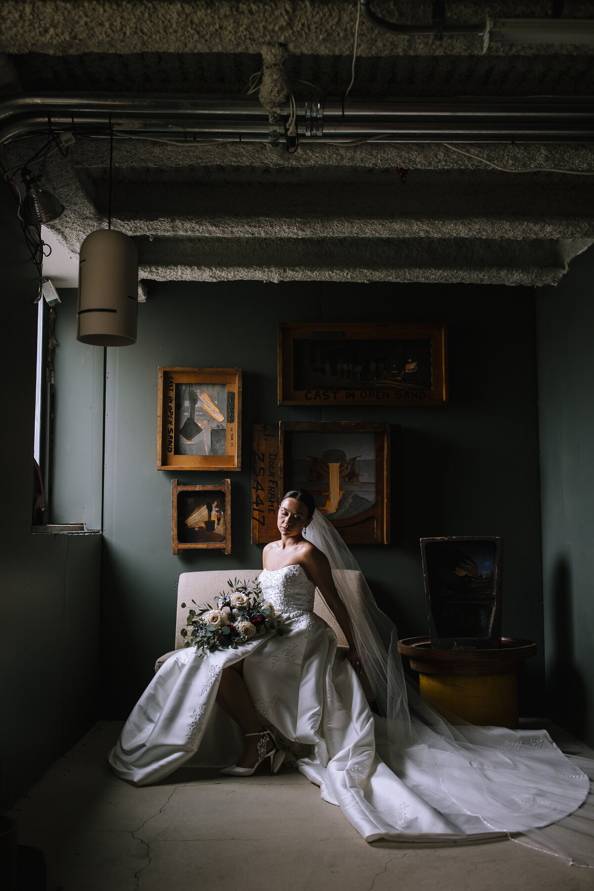 Bride in front of a painting at the Energy Innovation Center wedding. 