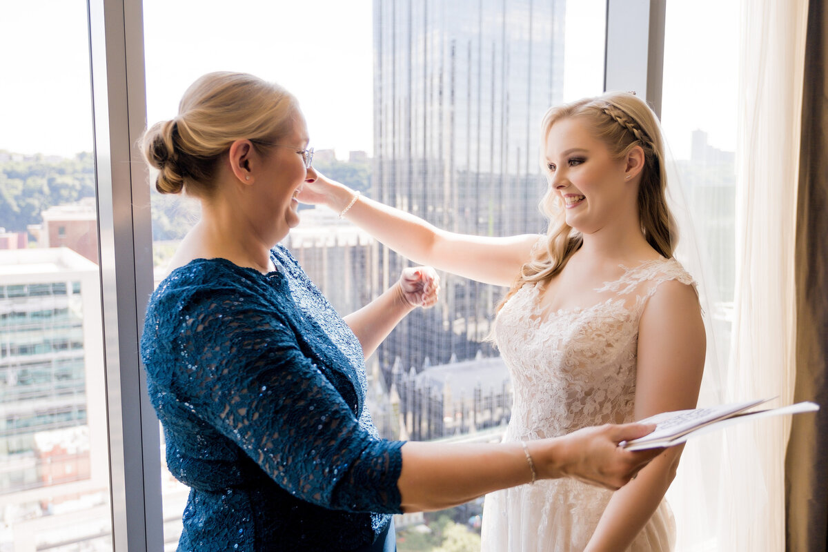 bride and mom hugging at her wedding at fairmont hotel getting ready suite