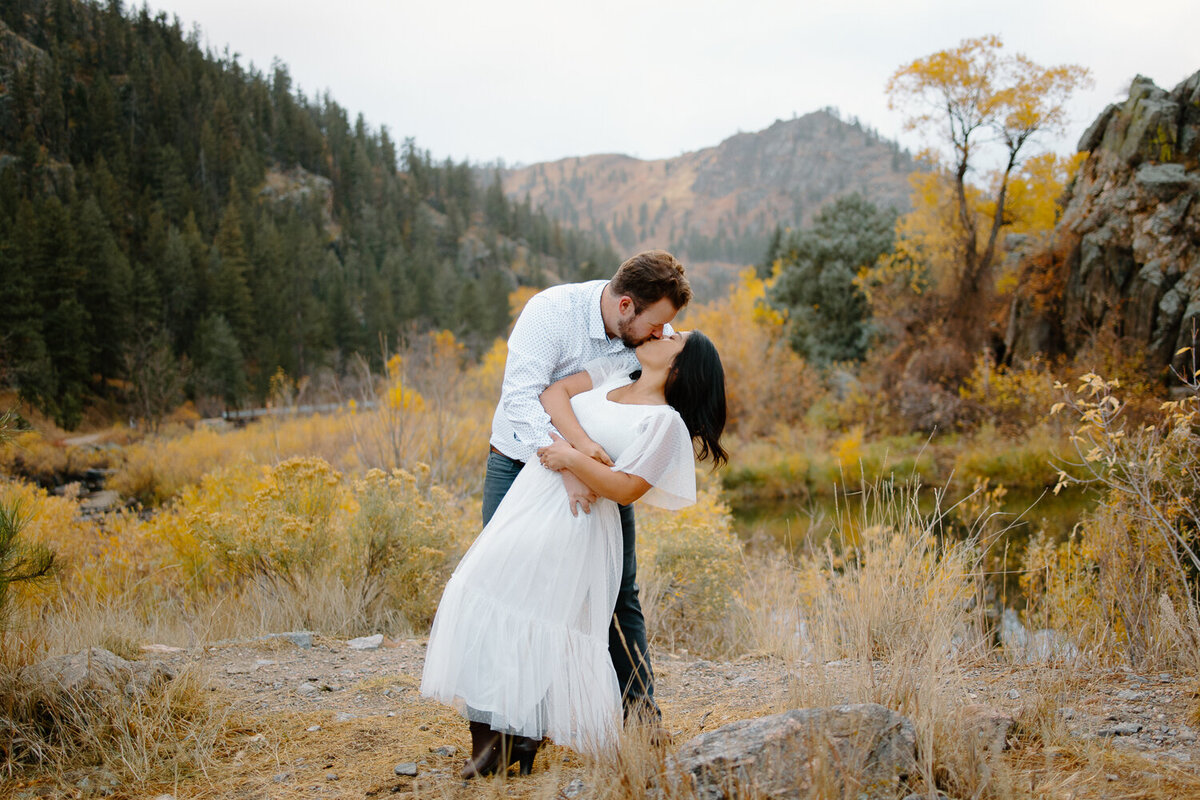 A couple kisses during their engagement session at Gateway Natural Area in Fort Collins, Colorado.