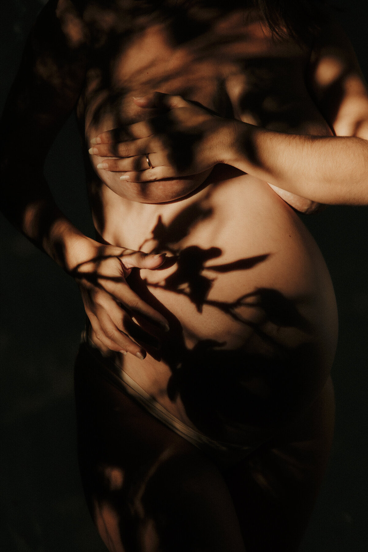 Close up of pregnant lady bump with shadows, Mudjimba Beach