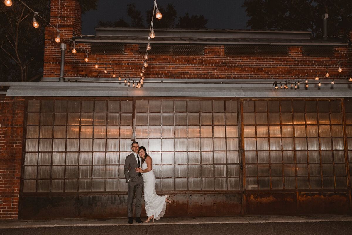 Bride and groom pose outside of their wedding in Denver, Colorado at Blanc.