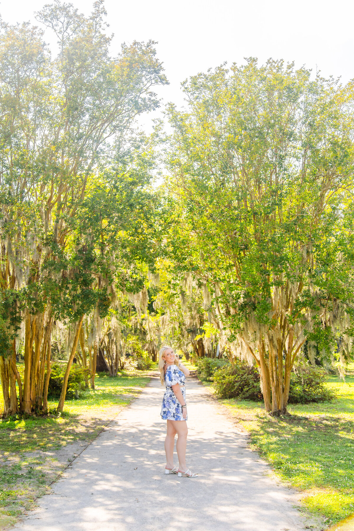 girl posing in blue and white boutique dress at hampton park in south carolina