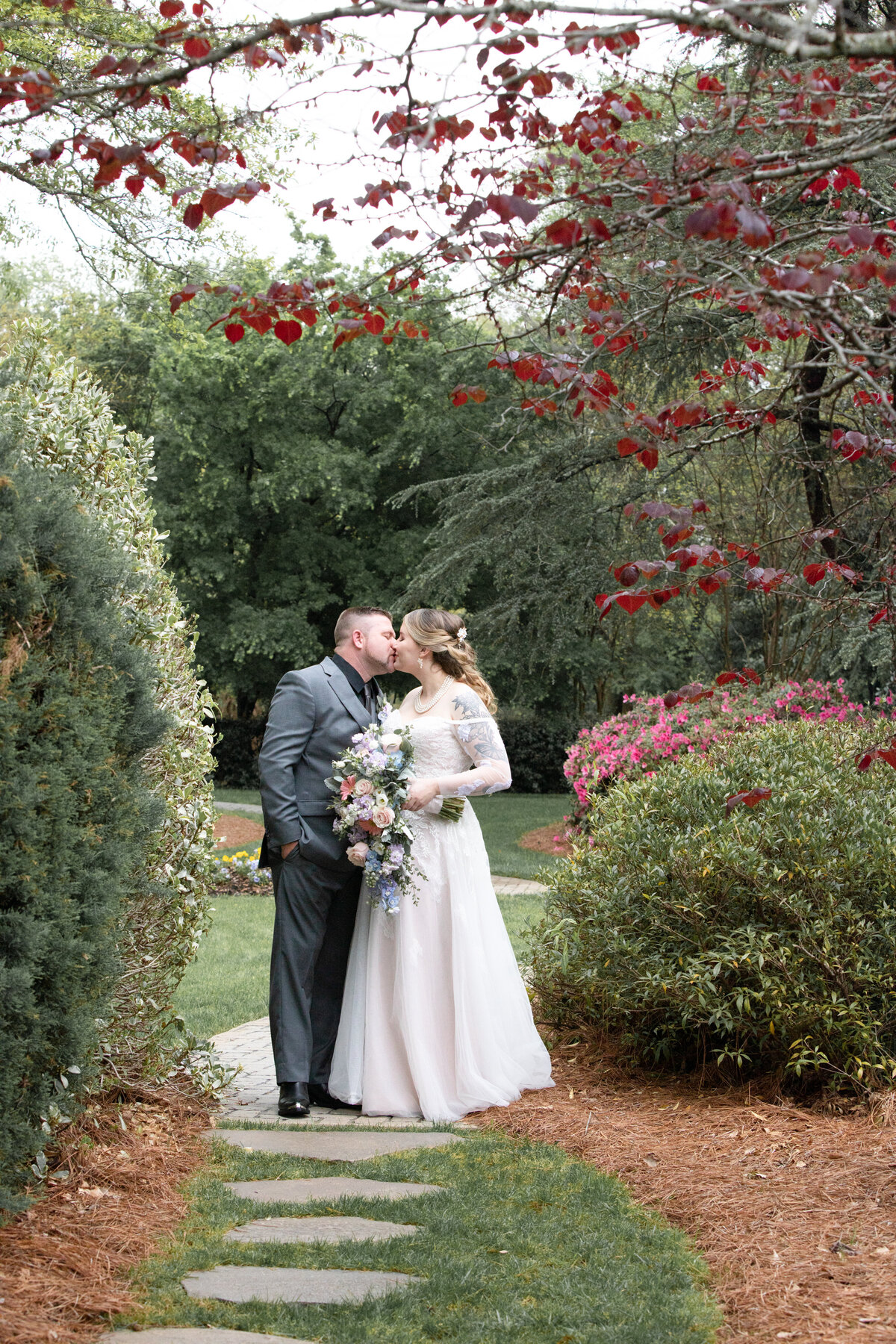 Carl-House-Auburn-GA-Bride-Groom-Kissing-Pathway-Garden-Wedding