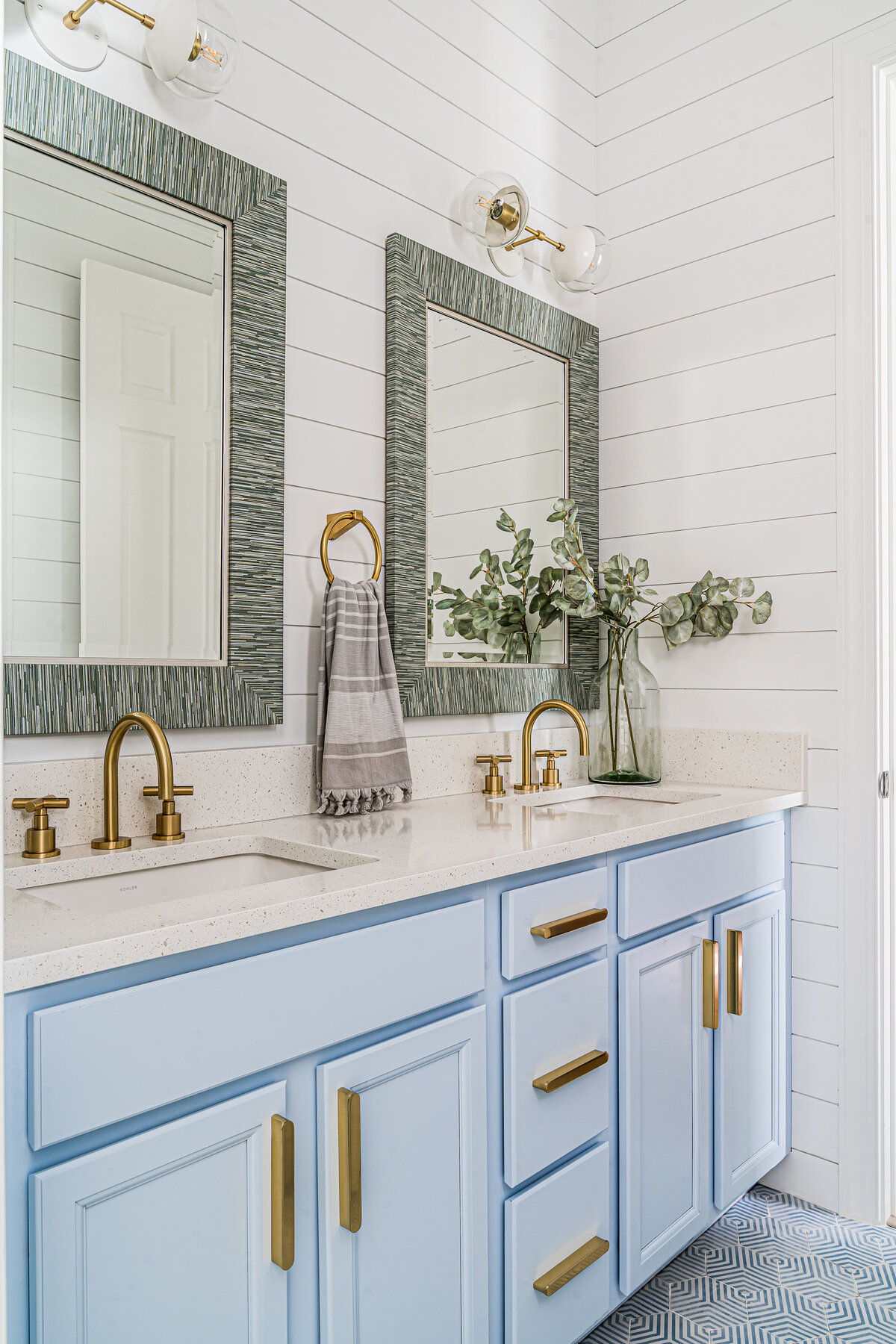 coastal home light blue guest bathroom vanity and mirrors Full Service Interior Design by Island Home Interiors Lake Nona