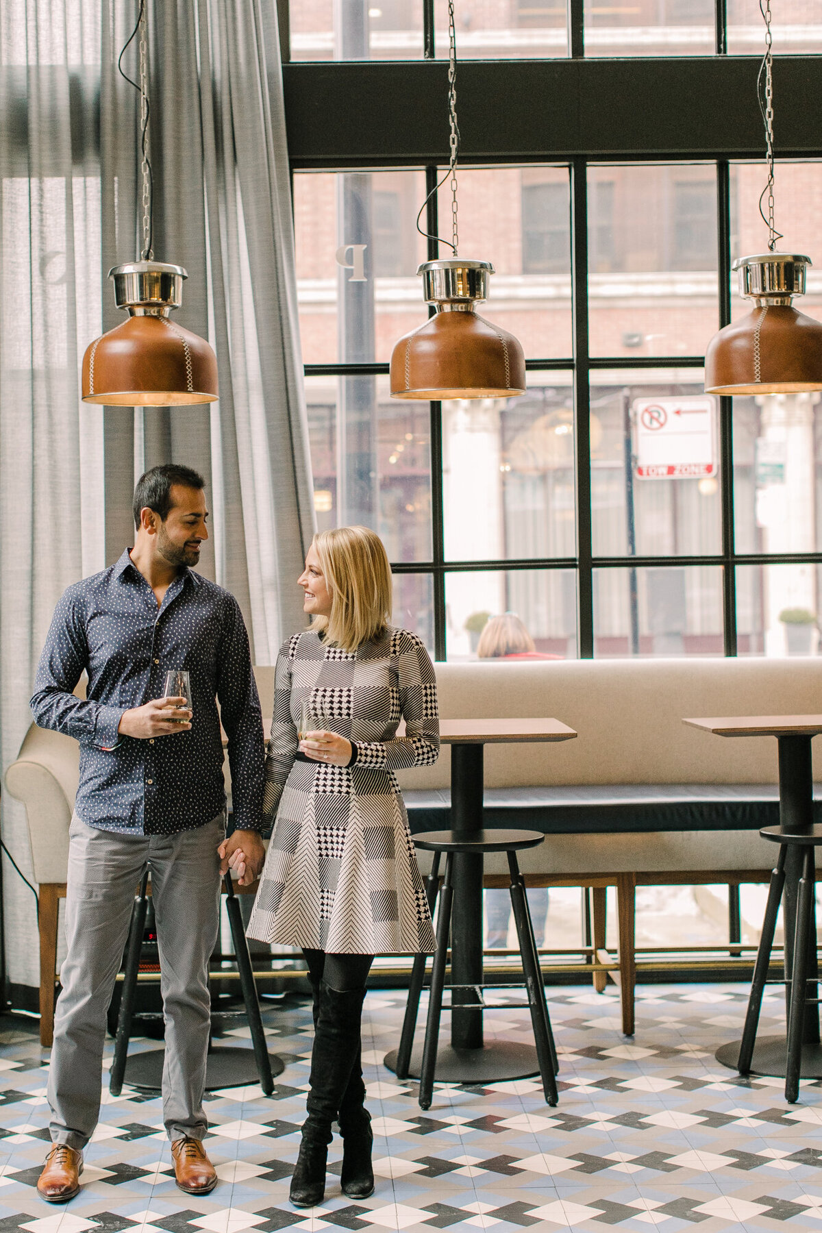 A couple poses for an engagement photo in their favorite West Loop bar in Chicago