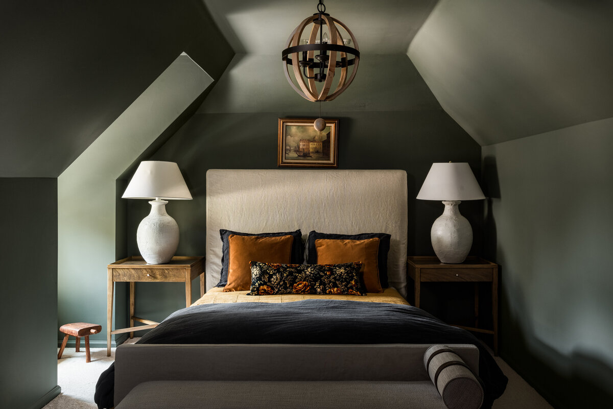 Cozy bedroom in Concord, NC, with neutral bedding, warm lighting, and a modern design.