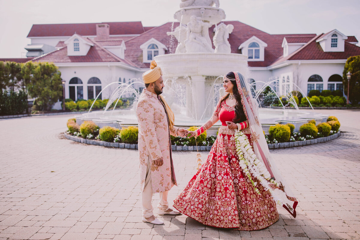 indian bride and groom have a first look during their hindu wedding day at the surf club in ny
