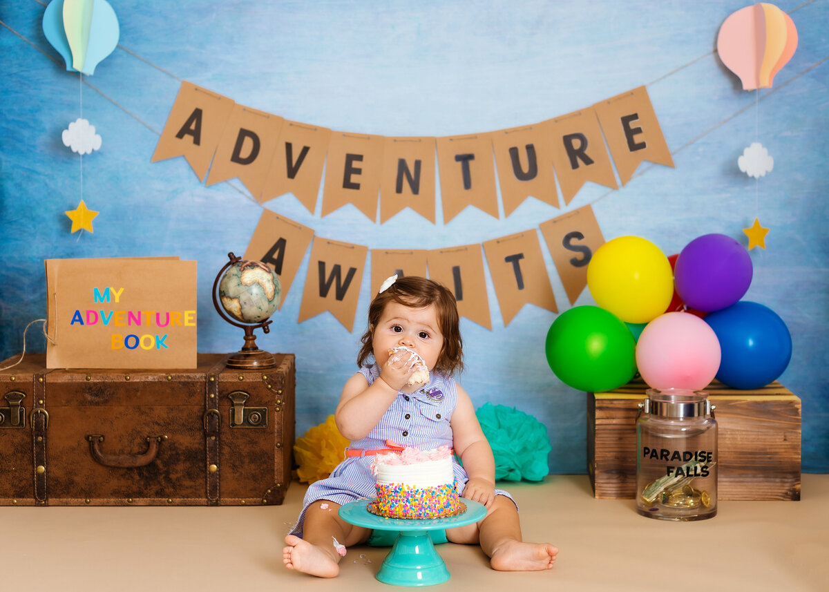 Cake Smash  Photographer, a baby celebrates first birthday before adventure awaits sign
