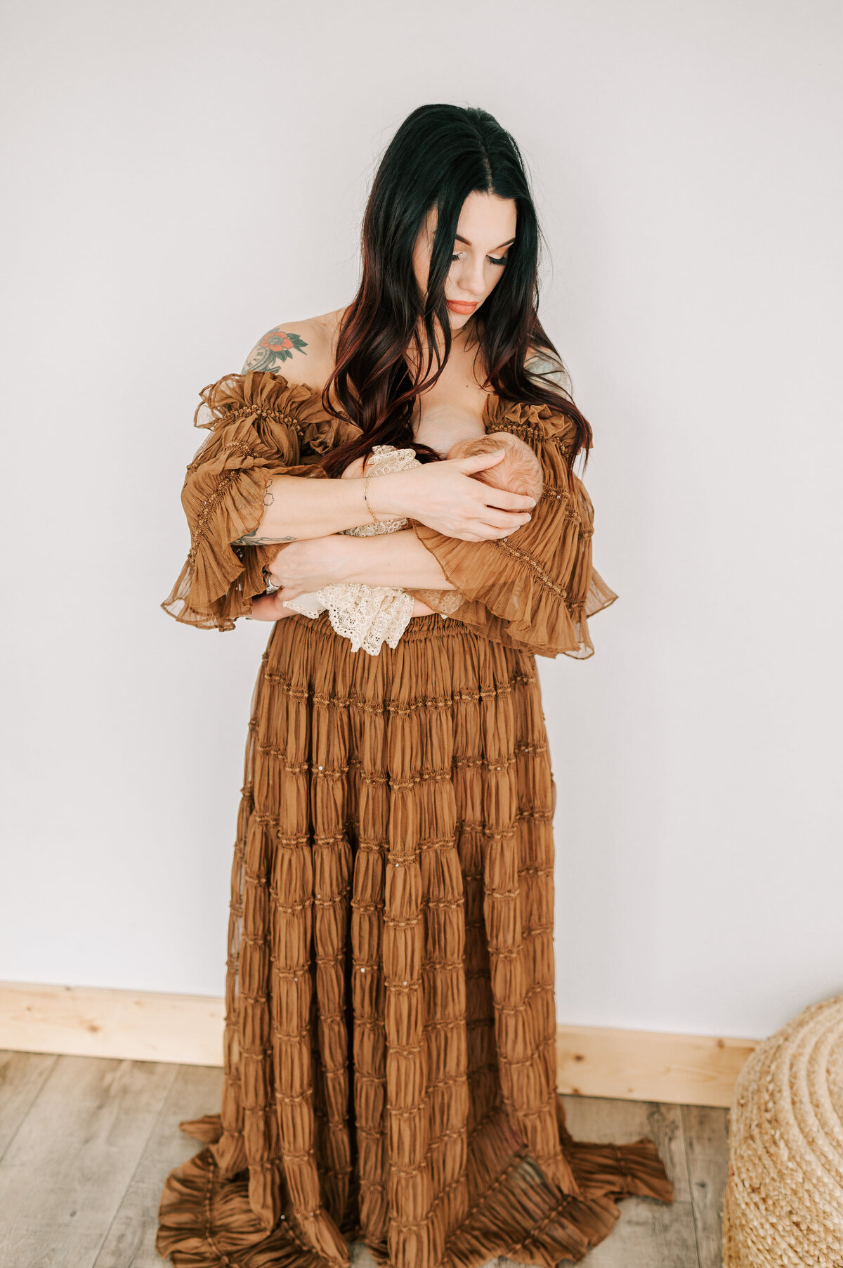 mom breastfeeding newborn in Springfield MO newborn photography studio