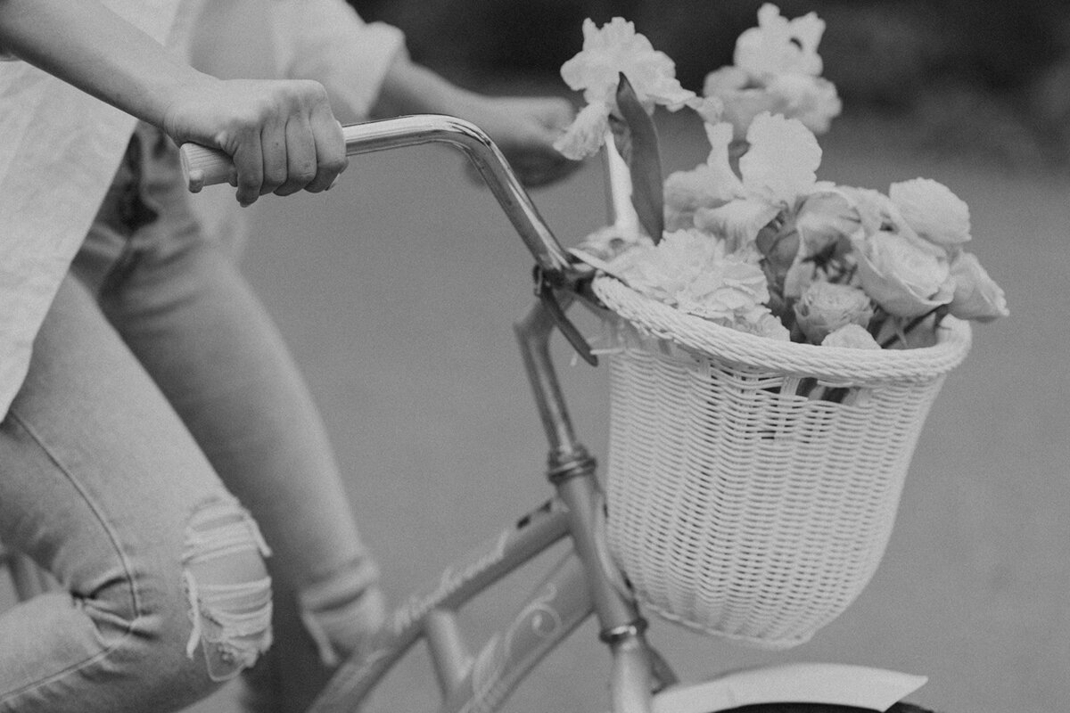 the-girls-is-riding-a-bicycle-wth-a-basket-of-flowers