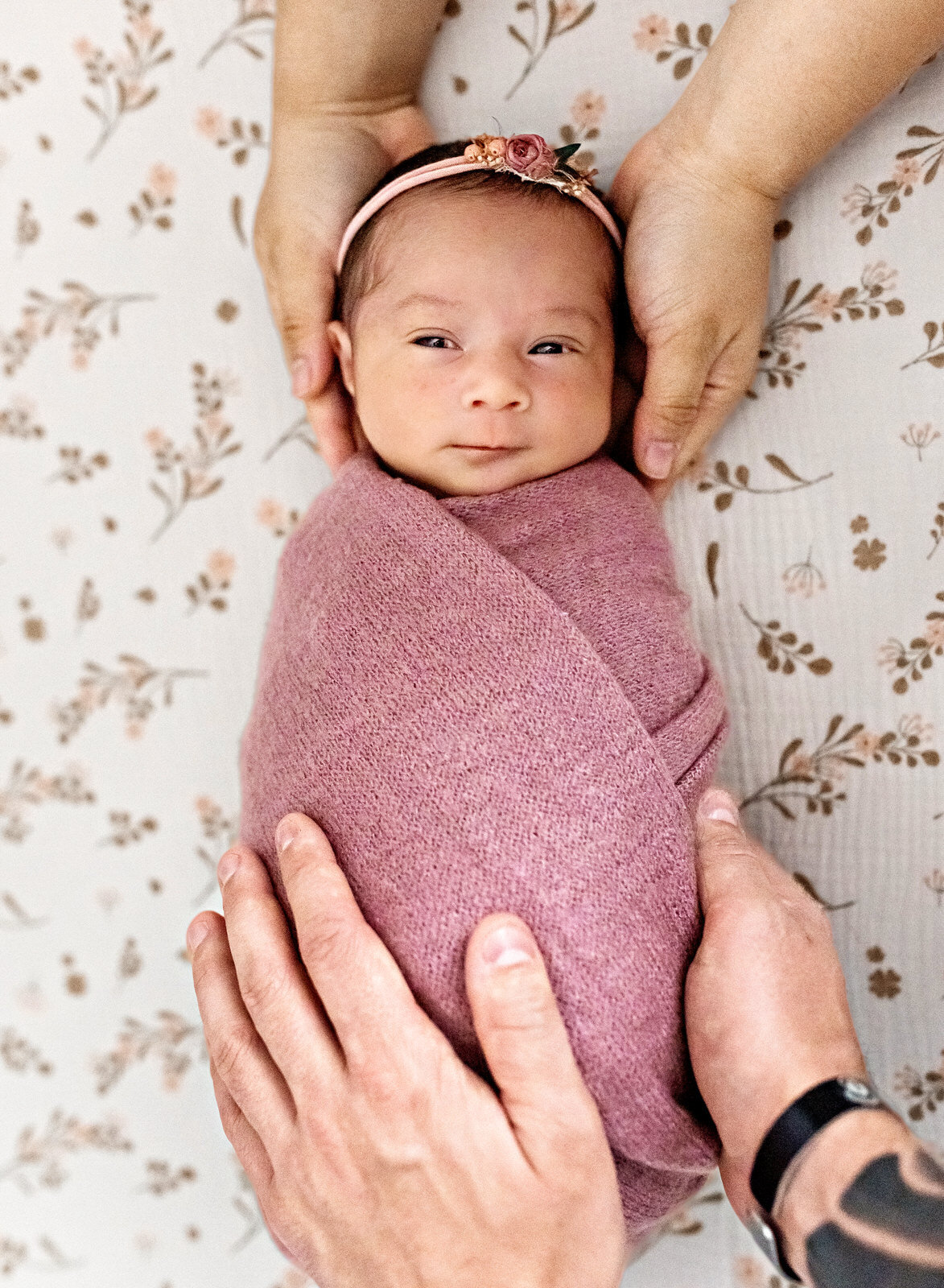 awake-baby-with-parents-hands