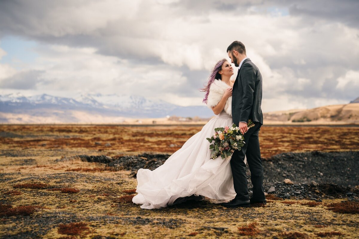 In the enchanting landscapes of Iceland, this couple shares a heartfelt moment, looking into each other's eyes and creating a memory filled with the beauty of their love.