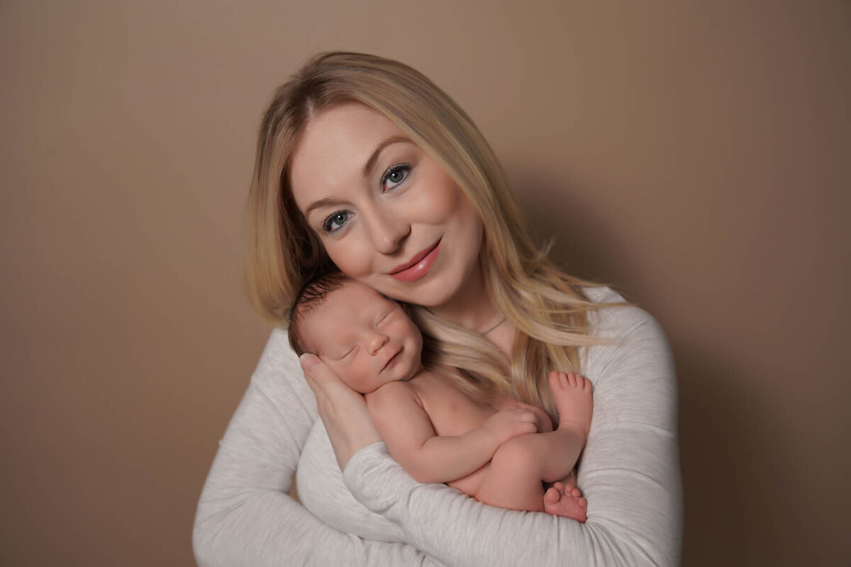 Mother holding her newborn for portraits