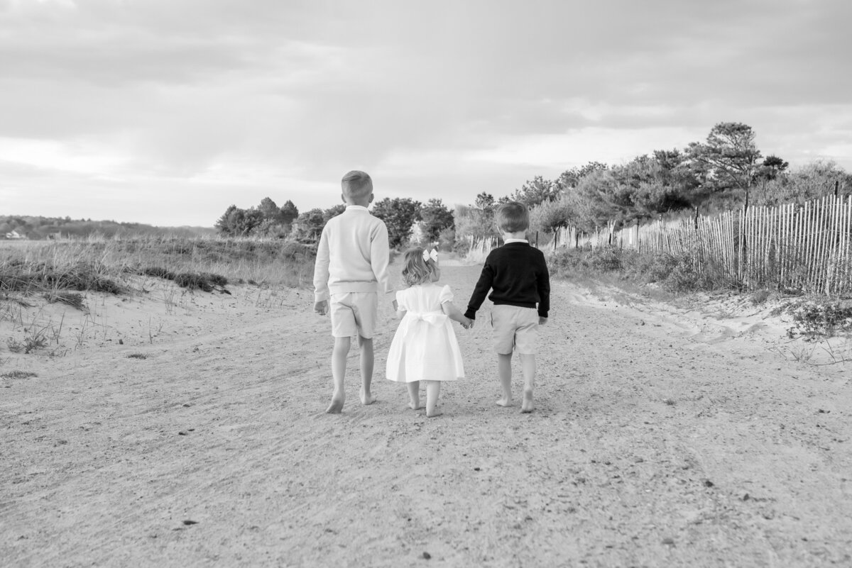 Portrait of 3 siblings walking together at the beach