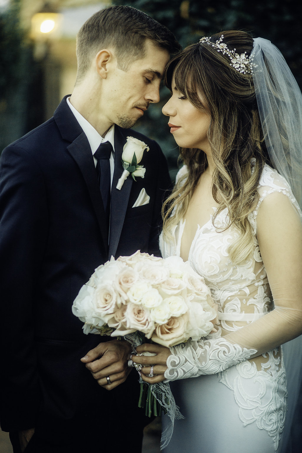 Wedding Photograph Of Bride Carrying a  Bouquet Next To Her Groom With Their Eyes Closed Los Angeles
