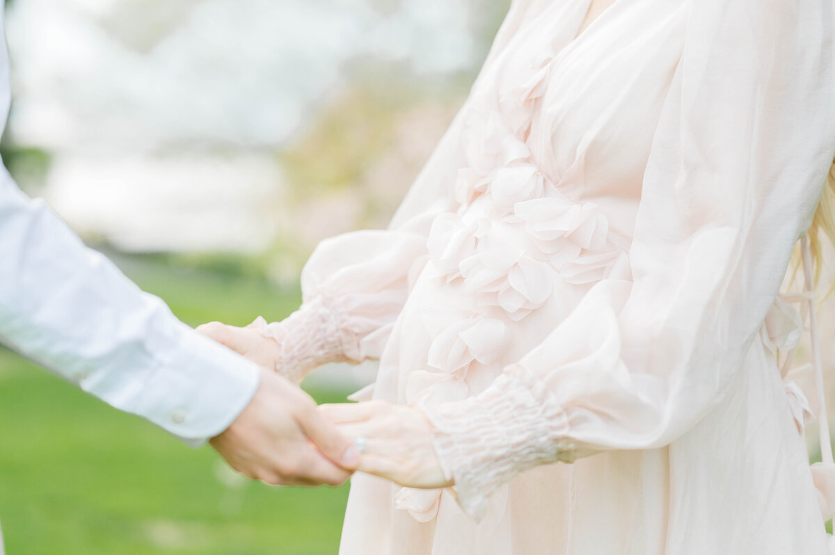 Pregnant belly and husband and wife holding hands in Bristol, RI at Blithewold Mansion taken by best Maternity photographer in Rhode Island