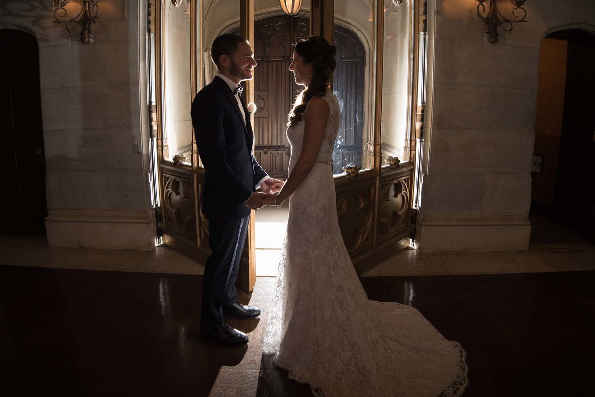 bride and groom holding hands and looking at one another at Hempstead House