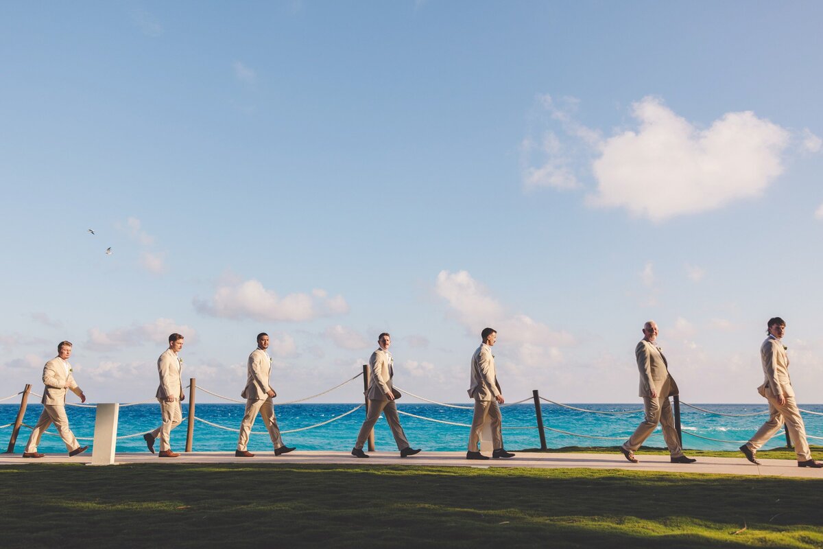 Groomsmen walking to ceremony at Hyatt Ziva Cancun wedding