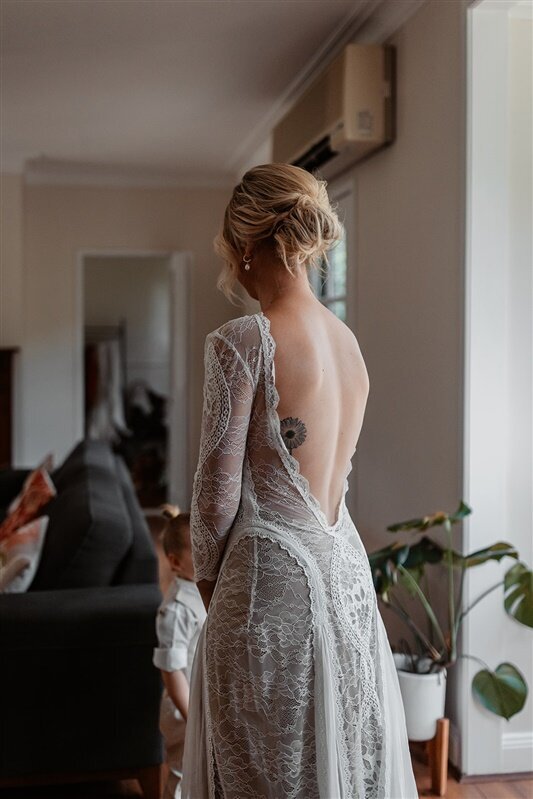"Capture the essence of elegance with our exquisite backshot photography, showcasing the intricate details of the bride's dress.