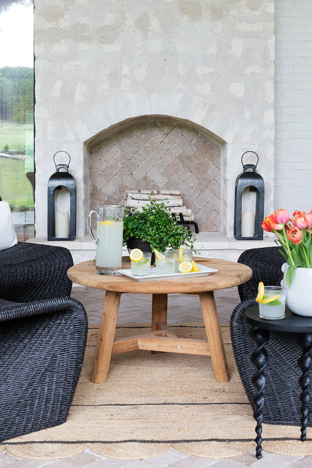 stone fireplace outside with seating