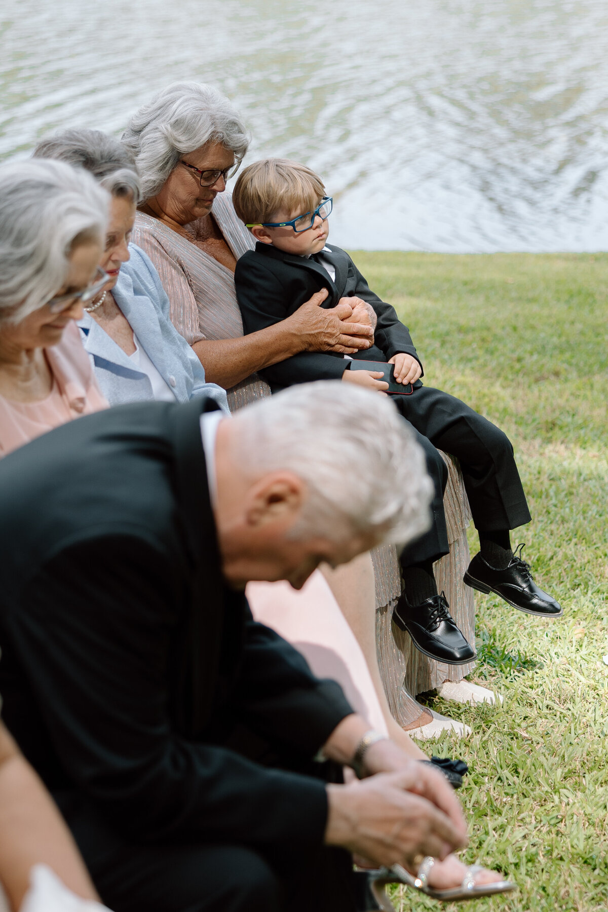 Grandmother holds the ring bearer during the ceremony.