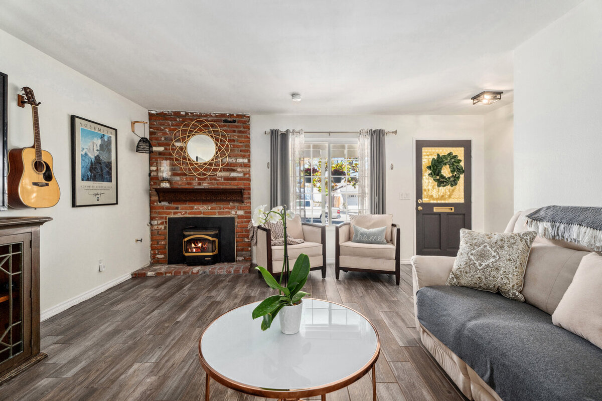 Front seating room and foyer of a home in Escondido, Ca. Small brick fireplace on the left side of the room.