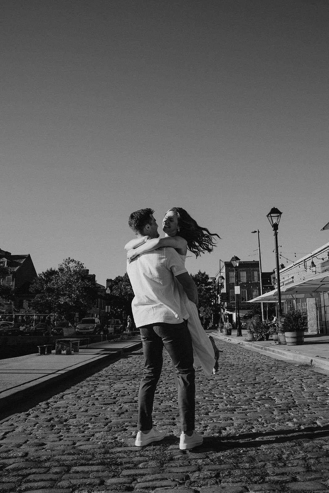 A person holding up their partner and twirling them 