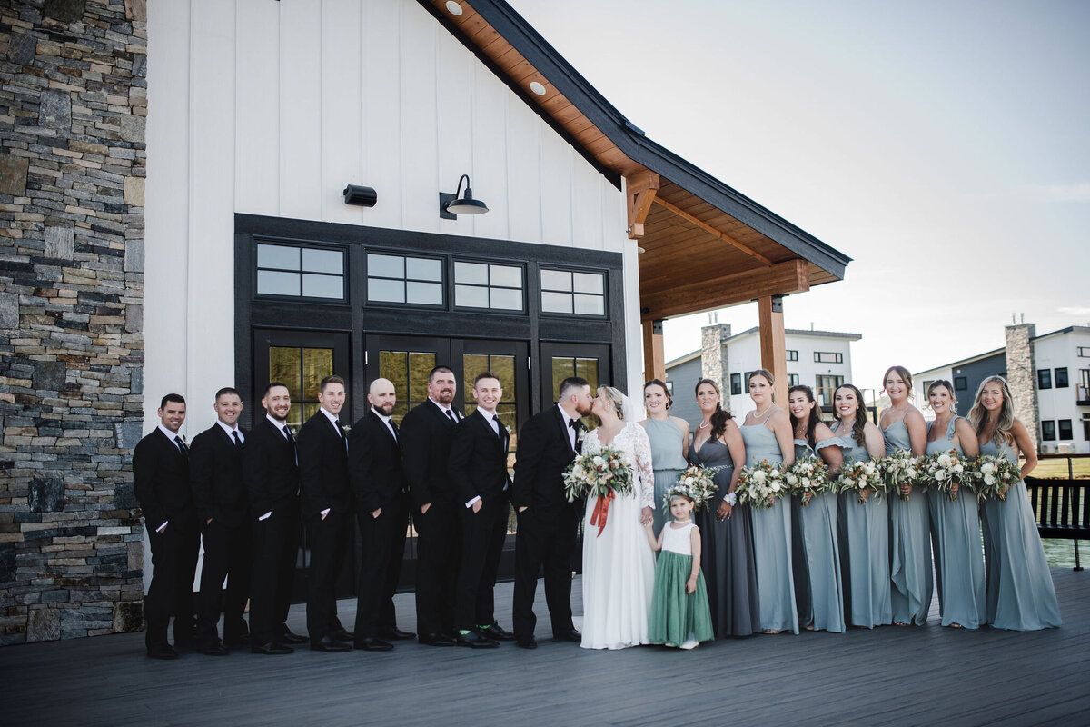 Bridal party standing outside at the Deck along the Lakehouse
