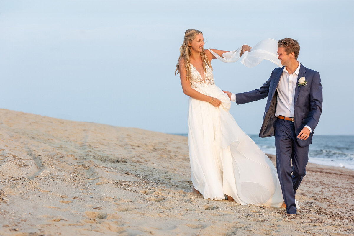 bridal-veil-in-wind-groom-alughing-on-beach-nantucket-lisa-gilbert-photography