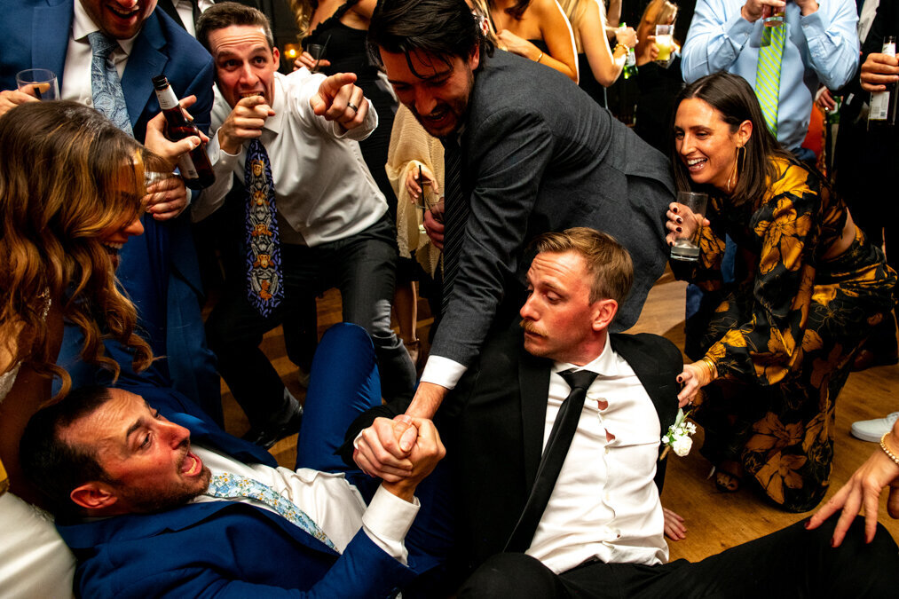 A group of people on the floor at a wedding.